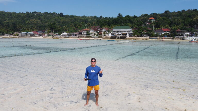 Bali beach guy blue shirt yankees hat